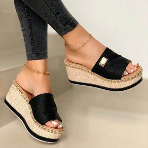 Slippers with thick soles and sloping heels are fashionable